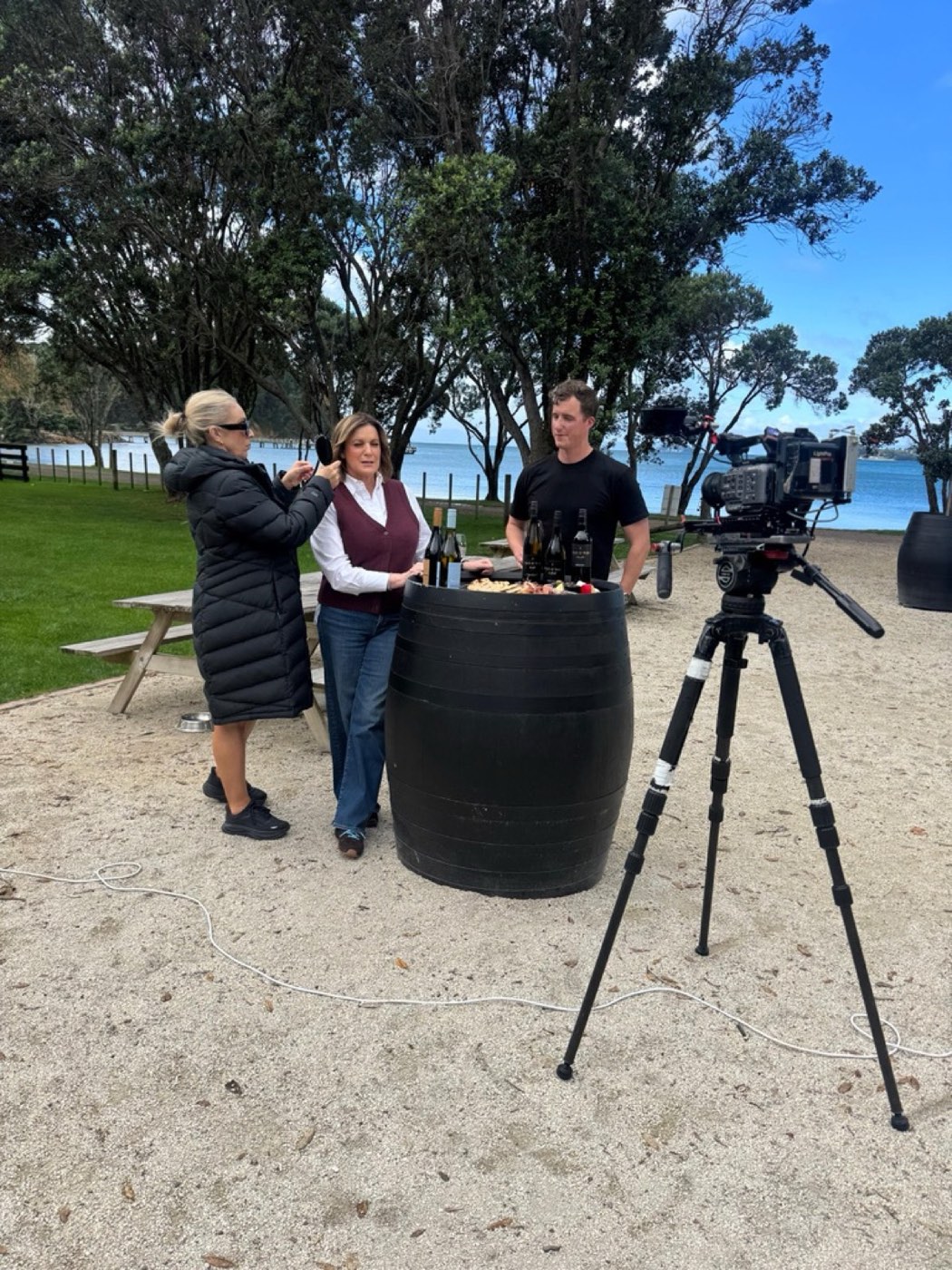 Presenter at a wine barrel being prepped for an outdoor interview
