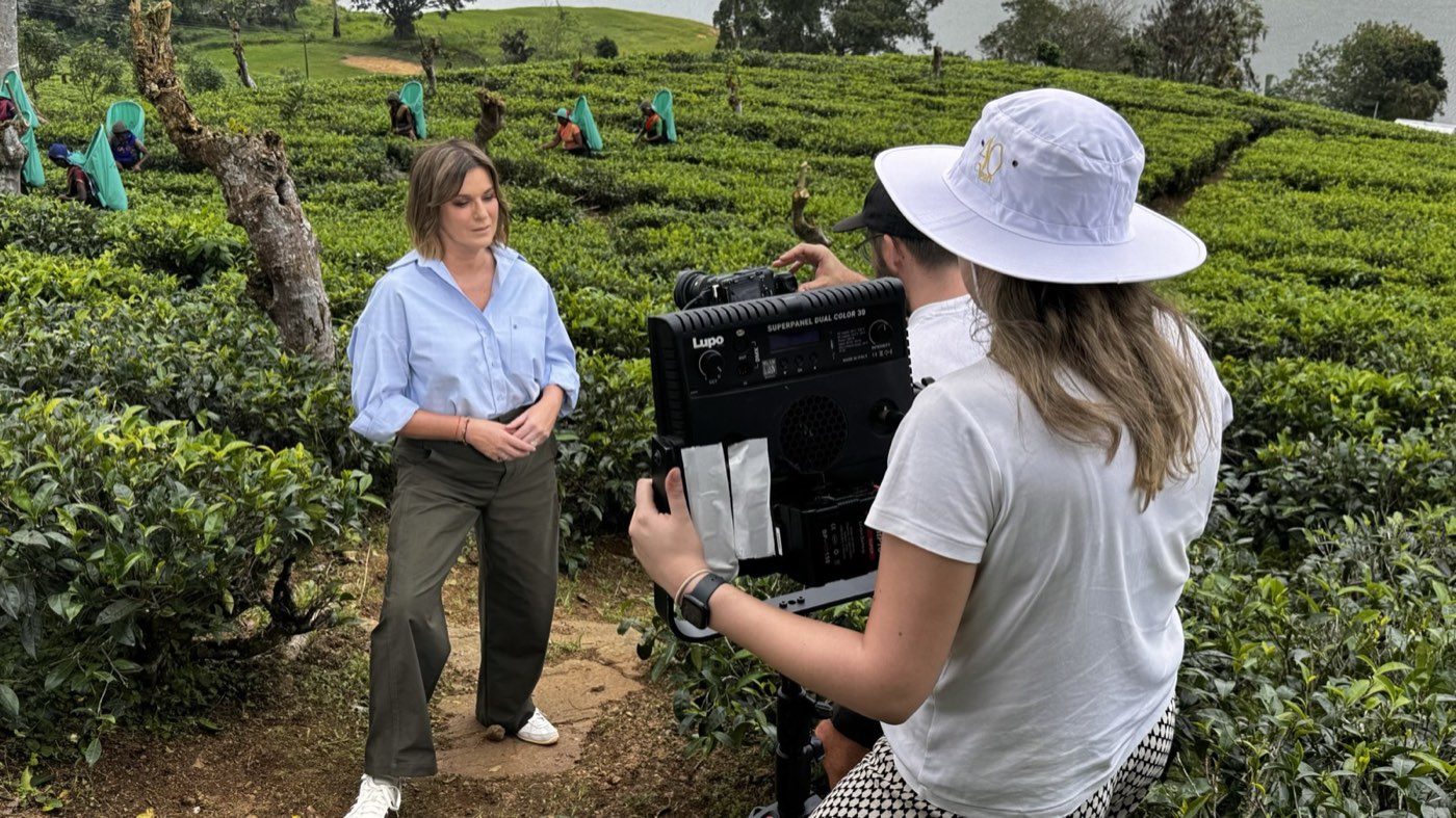 Presenter piece to camera in a tea plantation with camera operator